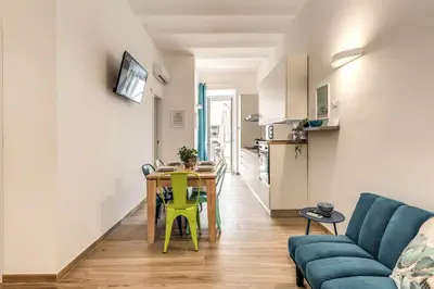 a living room with a table and a blue couch at NALA & KIRA - Two big apartments for groups in the center of Rome in Rome