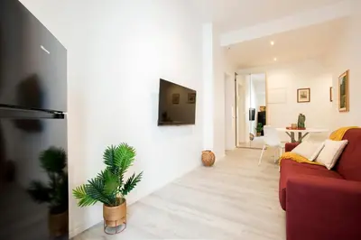 a living room with a red couch and a tv at Domus White in Rome