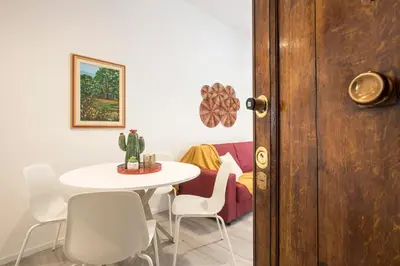 a dining room with a white table and chairs at Domus White in Rome