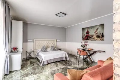 a bedroom with a bed and a table at Spanish Step Dream Suites in Rome