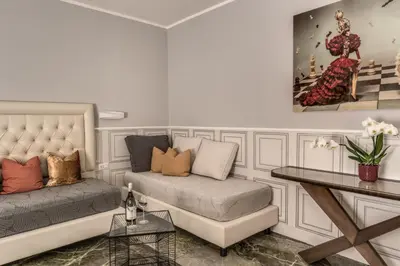 a living room with a couch and a table at Spanish Step Dream Suites in Rome