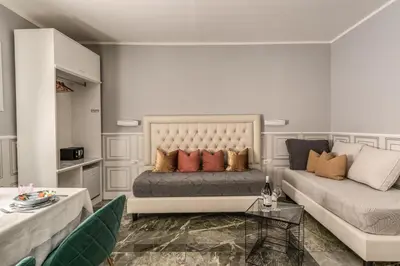 a living room with a bed and a couch at Spanish Step Dream Suites in Rome