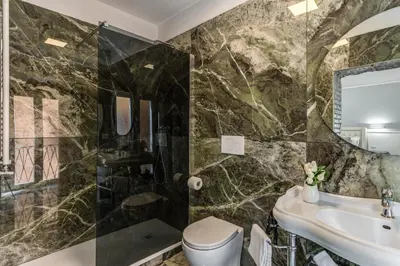 a bathroom with a sink and a toilet at Spanish Step Dream Suites in Rome