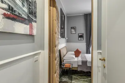a room with a bed and a table at Spanish Step Dream Suites in Rome