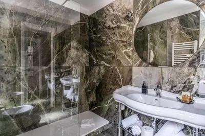 a bathroom with a sink and a mirror at Spanish Step Dream Suites in Rome