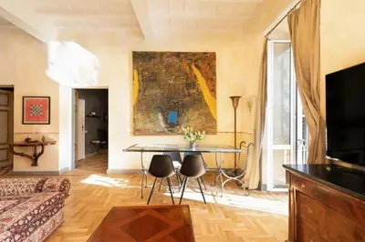 a living room with a table and a painting on the wall at Farnese Designer Loft by Romeloft in Rome