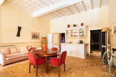 a living room with a table and a couch at Farnese Designer Loft by Romeloft in Rome