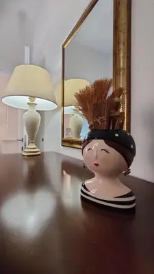 a doll with a hat on a table with a lamp at Il Nido di San Pietro - Cozy 2BR - Near Vatican in Rome