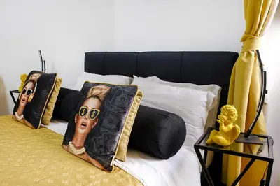 a bedroom with a bed with pillows with a headboard at Dea Clodia studio flat in Rome