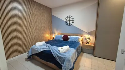a bedroom with a blue bed with towels on it at Light Blue Station Apartment in Rome