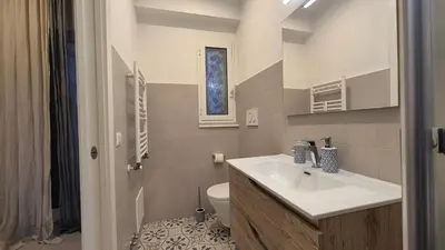a bathroom with a sink and a toilet at Light Blue Station Apartment in Rome