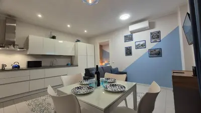 a dining room and kitchen with a table and chairs at Light Blue Station Apartment in Rome
