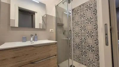 a bathroom with a sink and a shower at Light Blue Station Apartment in Rome