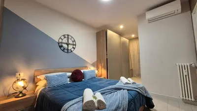 a bedroom with a blue bed with towels on it at Light Blue Station Apartment in Rome