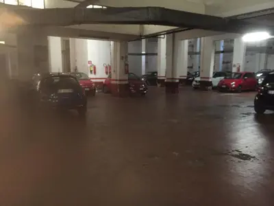 a parking garage with cars parked in it at Domus Appio Latino - Parco Appia Antica in Rome