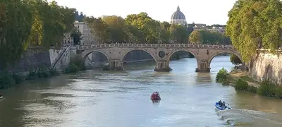 a bridge over a river with two boats in the water at Domus Appio Latino - Parco Appia Antica in Rome