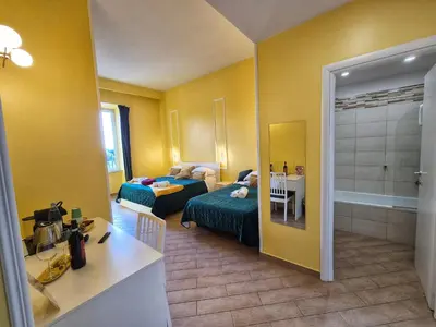 a hotel room with a bed and a bathroom at Residenze Serventi Longhi in Rome