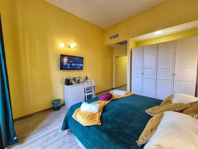 a bedroom with a blue bed with two pillows at Residenze Serventi Longhi in Rome