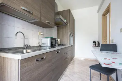 a kitchen with a sink and a counter top at Portside Aparthotel in Rome