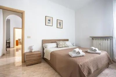 a bedroom with a bed with two towels on it at Portside Aparthotel in Rome