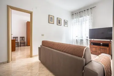 a living room with a couch and a flat screen tv at Portside Aparthotel in Rome