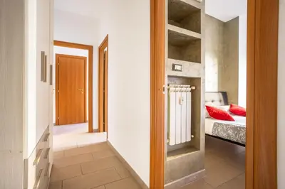 a hallway leading to a bedroom with a bed at Portside Aparthotel in Rome