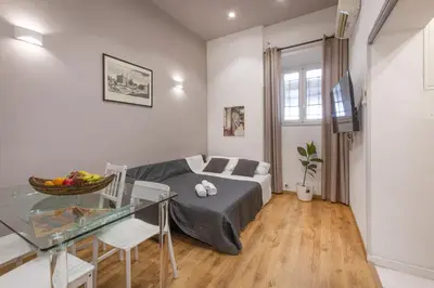 a living room with a couch and a glass table at Sweet House Campo de’ Fiori in Rome
