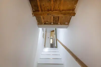 a stairway with white walls and a wooden ceiling at Sweet House Campo de’ Fiori in Rome
