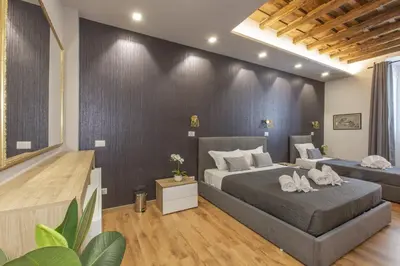 a bedroom with a bed and a wall at Sweet House Campo de’ Fiori in Rome