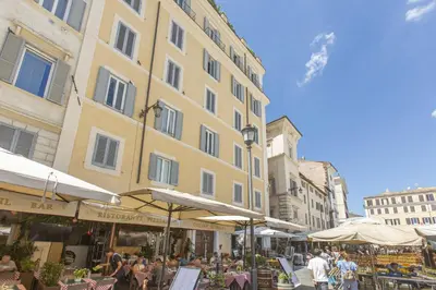 a group of people sitting at tables in front of a building at Sweet House Campo de’ Fiori in Rome