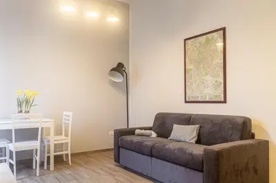 a living room with a couch and a table at [Flaminio * * * * *] - Loft con Giardino in Rome