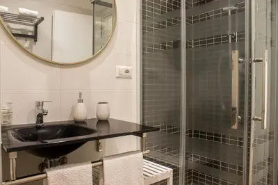 a bathroom with a sink and a glass shower at [Flaminio * * * * *] - Loft con Giardino in Rome