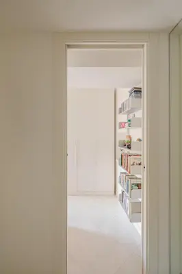 a door leading into a room with a book shelf at Cesarina Home in Rome