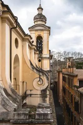 a building with a staircase leading up to a clock tower at Cesarina Home in Rome