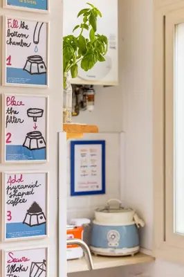 a kitchen with a counter with signs on the wall at Donna Olimpia tra Gianicolo e Trastevere in Rome