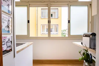 a kitchen with three windows and a counter top at Donna Olimpia tra Gianicolo e Trastevere in Rome