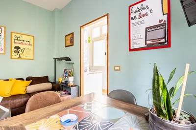 a living room with a table and a couch at Donna Olimpia tra Gianicolo e Trastevere in Rome