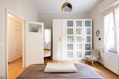 a room with a bed and a chair and a mirror at Donna Olimpia tra Gianicolo e Trastevere in Rome
