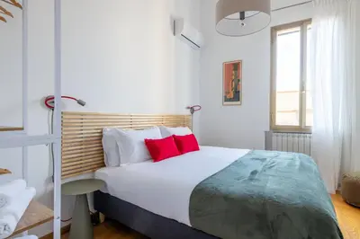 a bedroom with a large bed with red pillows at Elegant Apt with Two Bedrooms in Rome