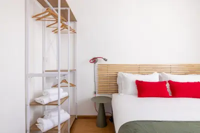 a bedroom with a white bed and red pillows at Elegant Apt with Two Bedrooms in Rome