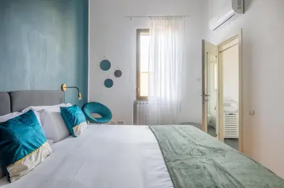 a bedroom with a large bed with blue walls at Elegant Apt with Two Bedrooms in Rome