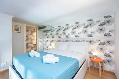 a bedroom with a bed with towels on it at Colosseum bright two Bedroom Apartment in Rome