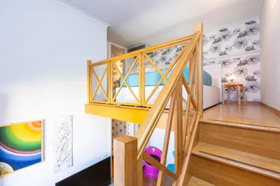 a room with stairs and a rainbow mural at Colosseum bright two Bedroom Apartment in Rome