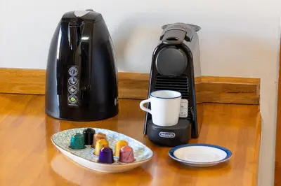 a coffee maker sitting on a table next to a plate at Colosseum bright two Bedroom Apartment in Rome