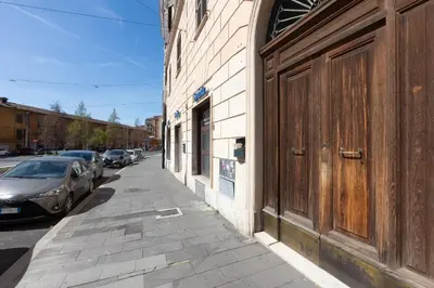 a street with cars parked on the side of a building at Colosseum bright two Bedroom Apartment in Rome