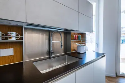 a kitchen with a sink and a counter top at Casa del Marchese del Grillo in Rome