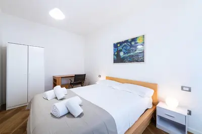 a bedroom with a large white bed with two pillows at Casa del Marchese del Grillo in Rome