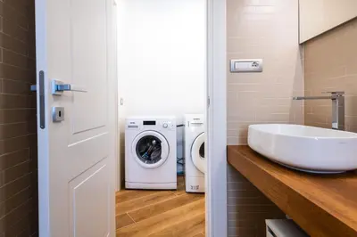 a bathroom with a sink and a washing machine at Casa del Marchese del Grillo in Rome