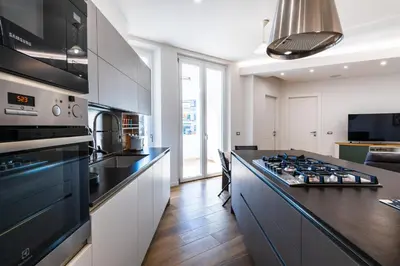 a kitchen with a stove top oven next to a counter at Casa del Marchese del Grillo in Rome