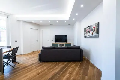 a living room with a couch and a television at Casa del Marchese del Grillo in Rome